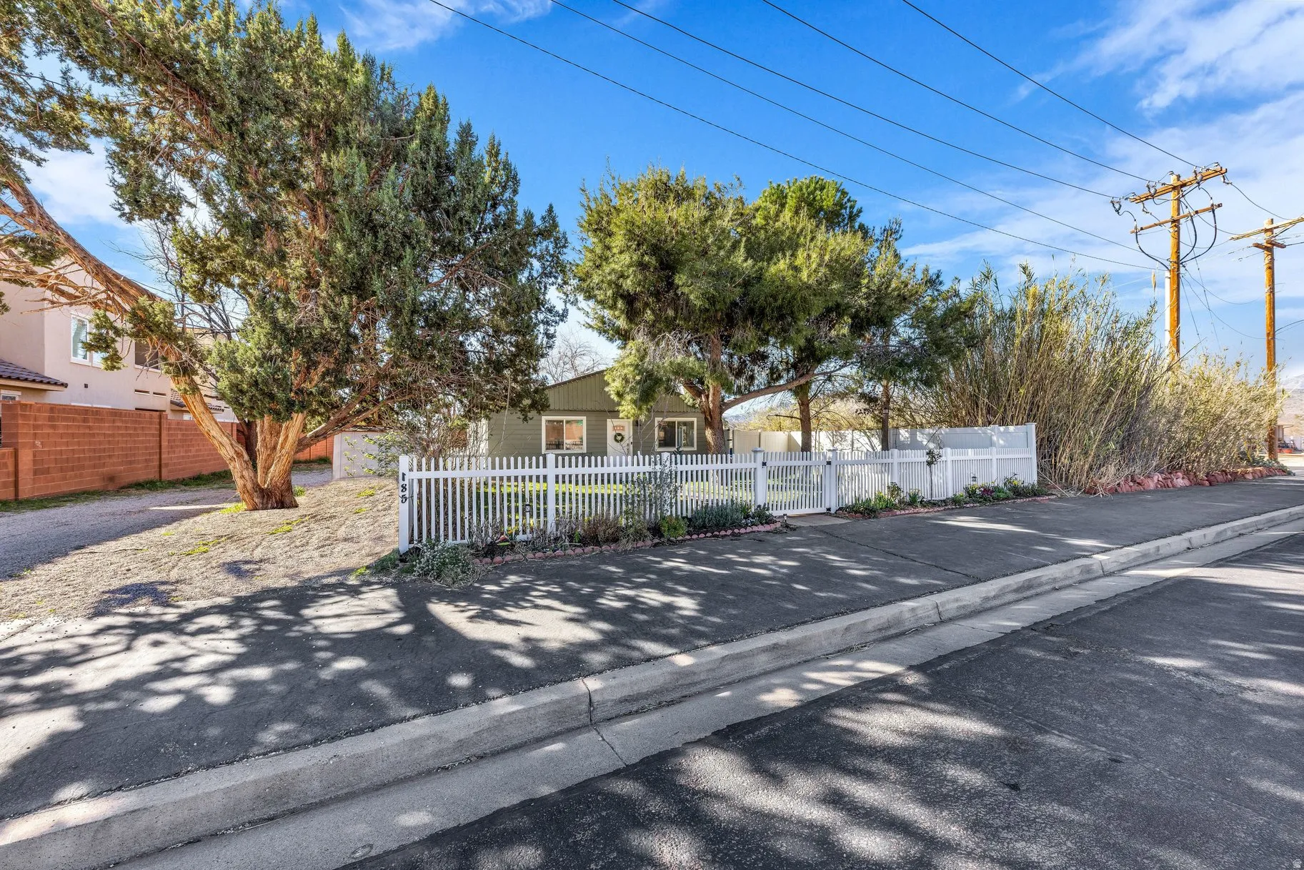 View of asphalt street featuring curbs