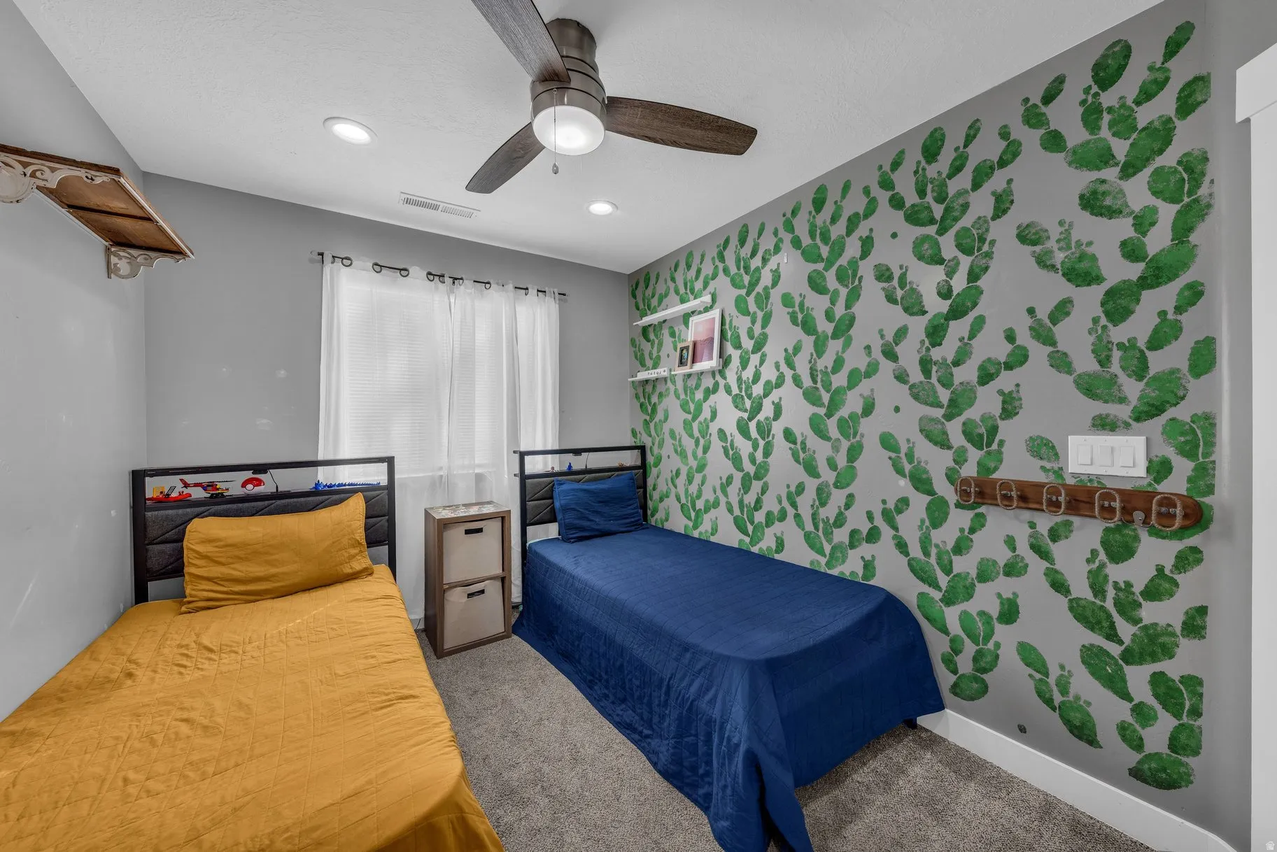 Bedroom with wallpapered walls, an accent wall, carpet, a ceiling fan, and recessed lighting