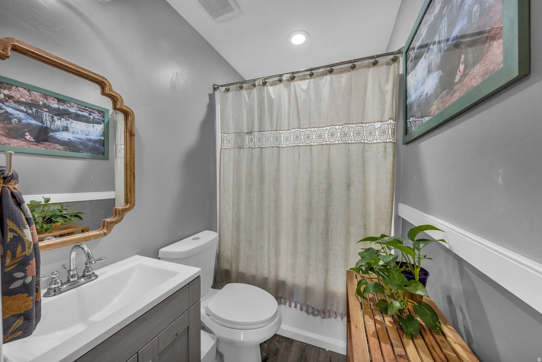 Bathroom with vanity, shower / bathtub combination with curtain, and recessed lighting