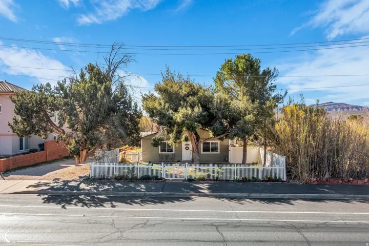 Obstructed view of property with a fenced front yard