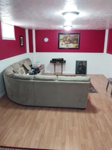 Living room featuring light wood-style floors and a textured ceiling
