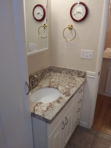 Bathroom featuring vanity and a textured wall