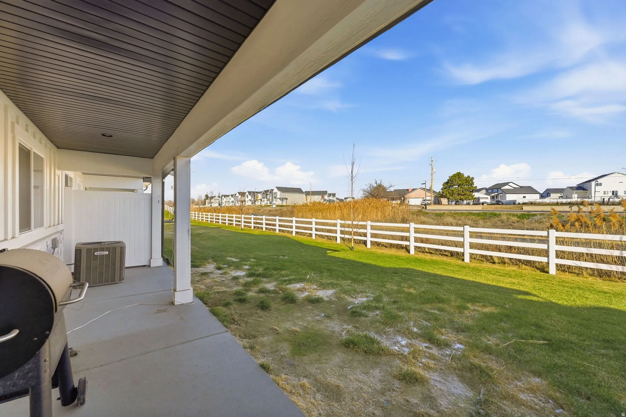 Fenced backyard with a residential view