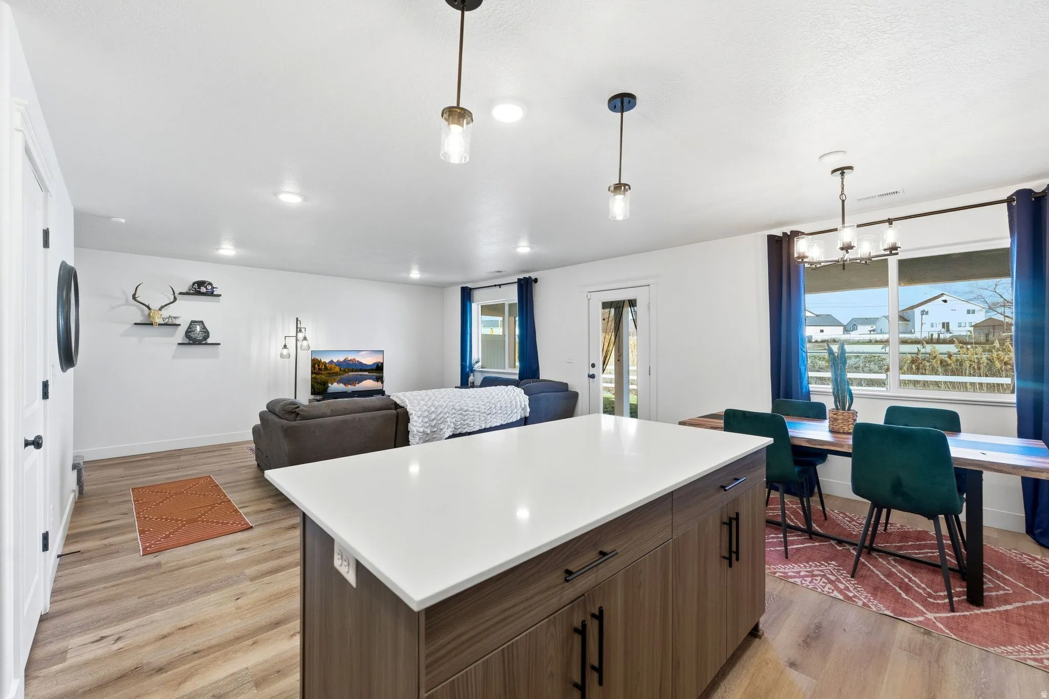 Kitchen with a center island, light wood-style flooring, open floor plan, light countertops, and healthy amount of natural light