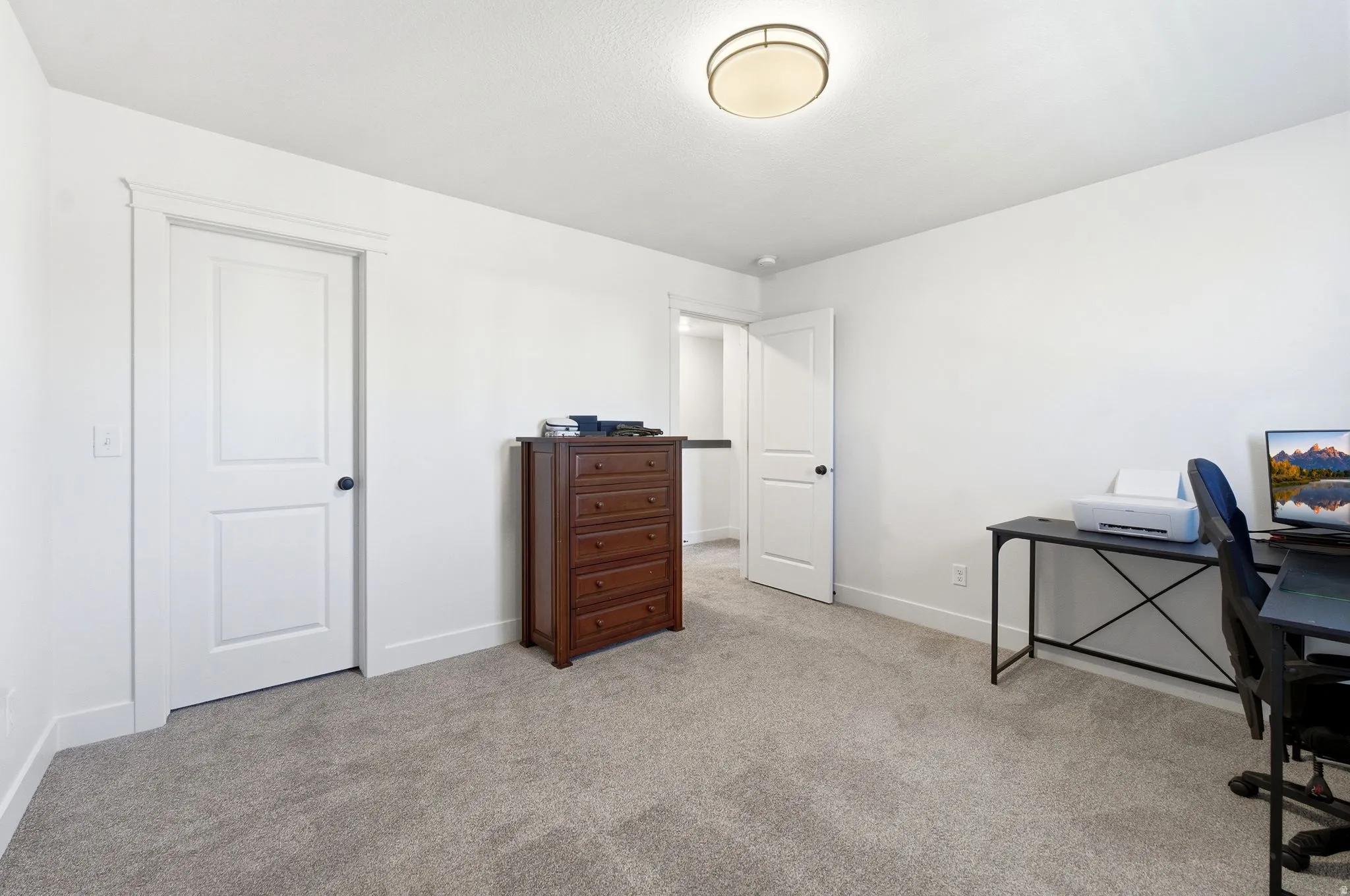Office featuring baseboards and light carpet
