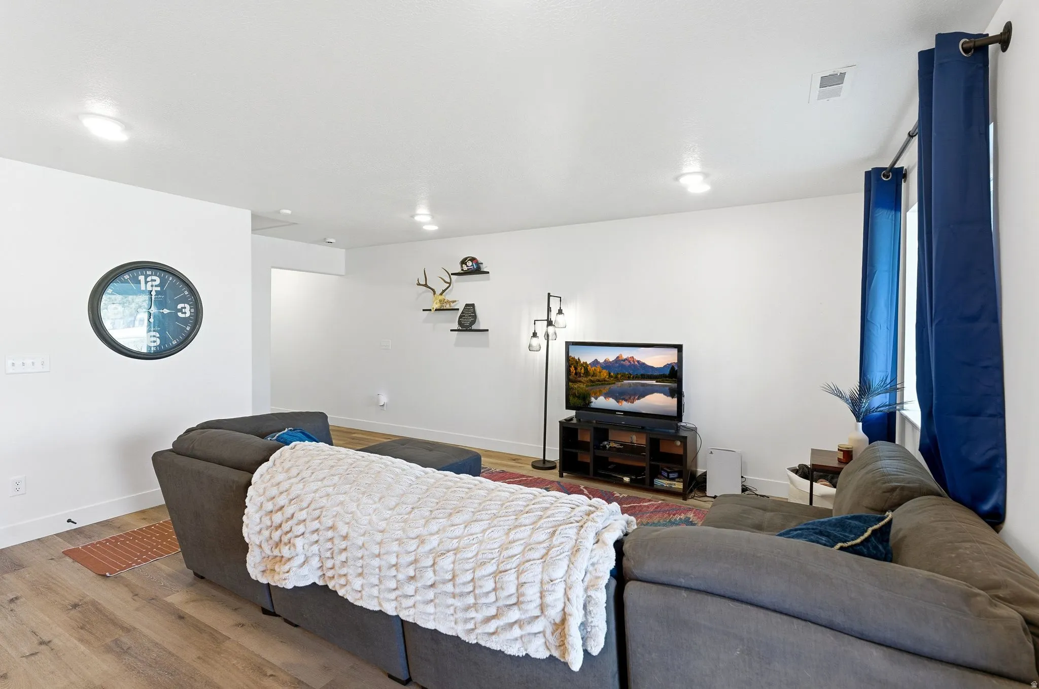 Living room with baseboards and wood finished floors
