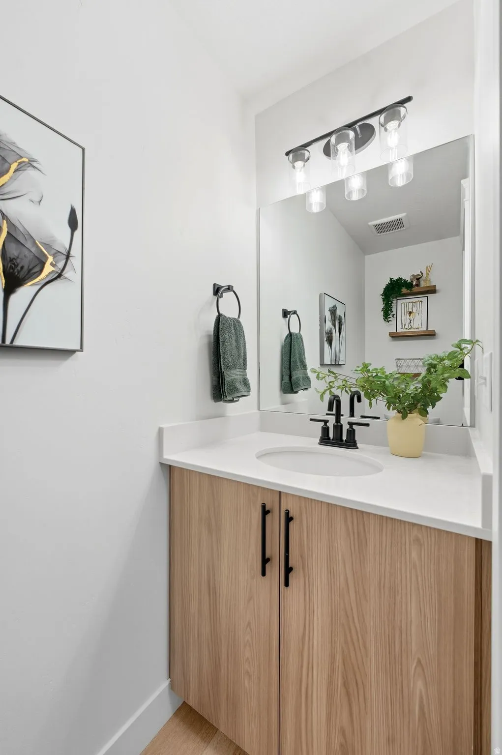 Bathroom featuring vanity and light wood-style floors