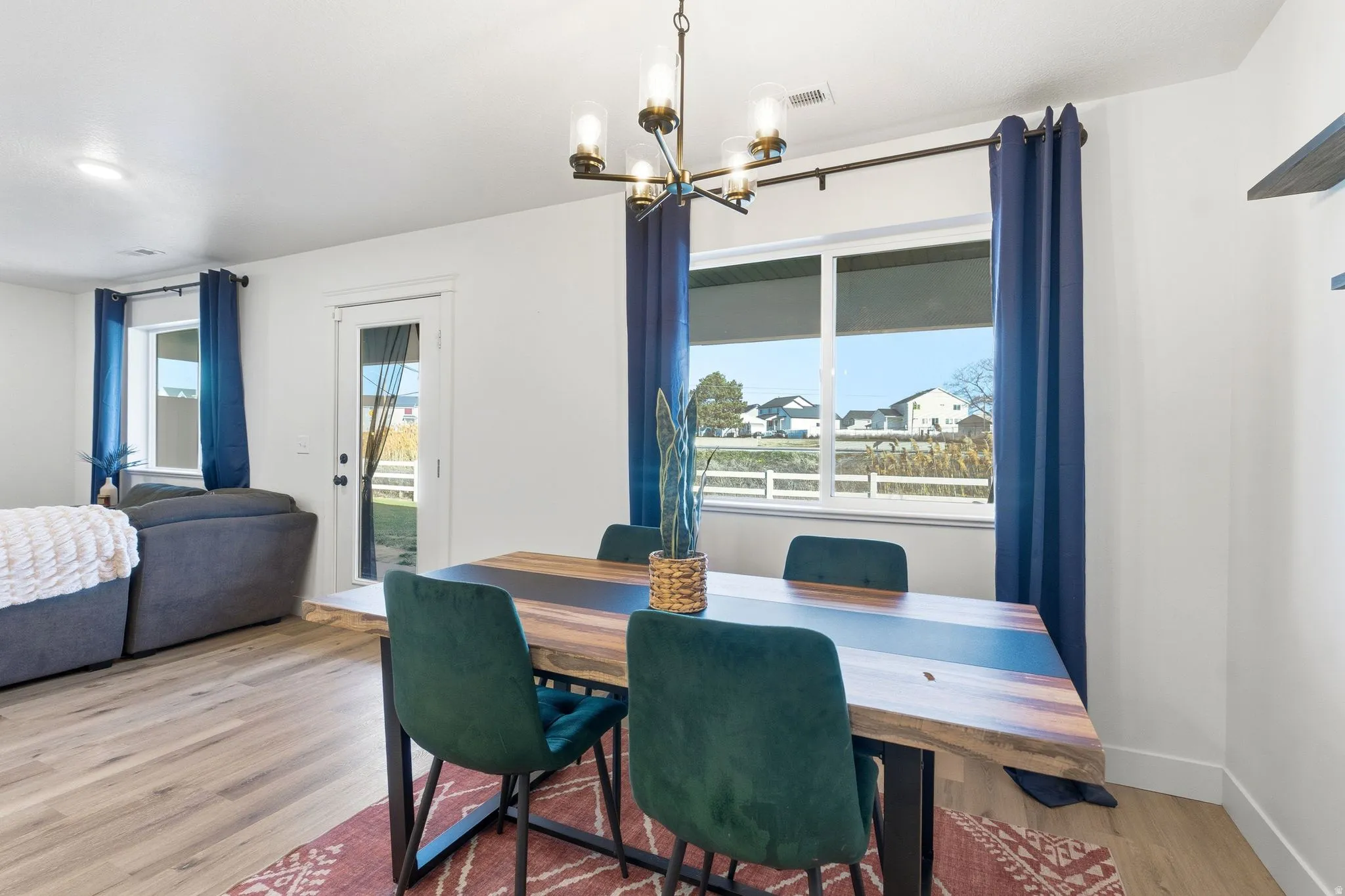 Dining room featuring wood finished floors and suspended lighting