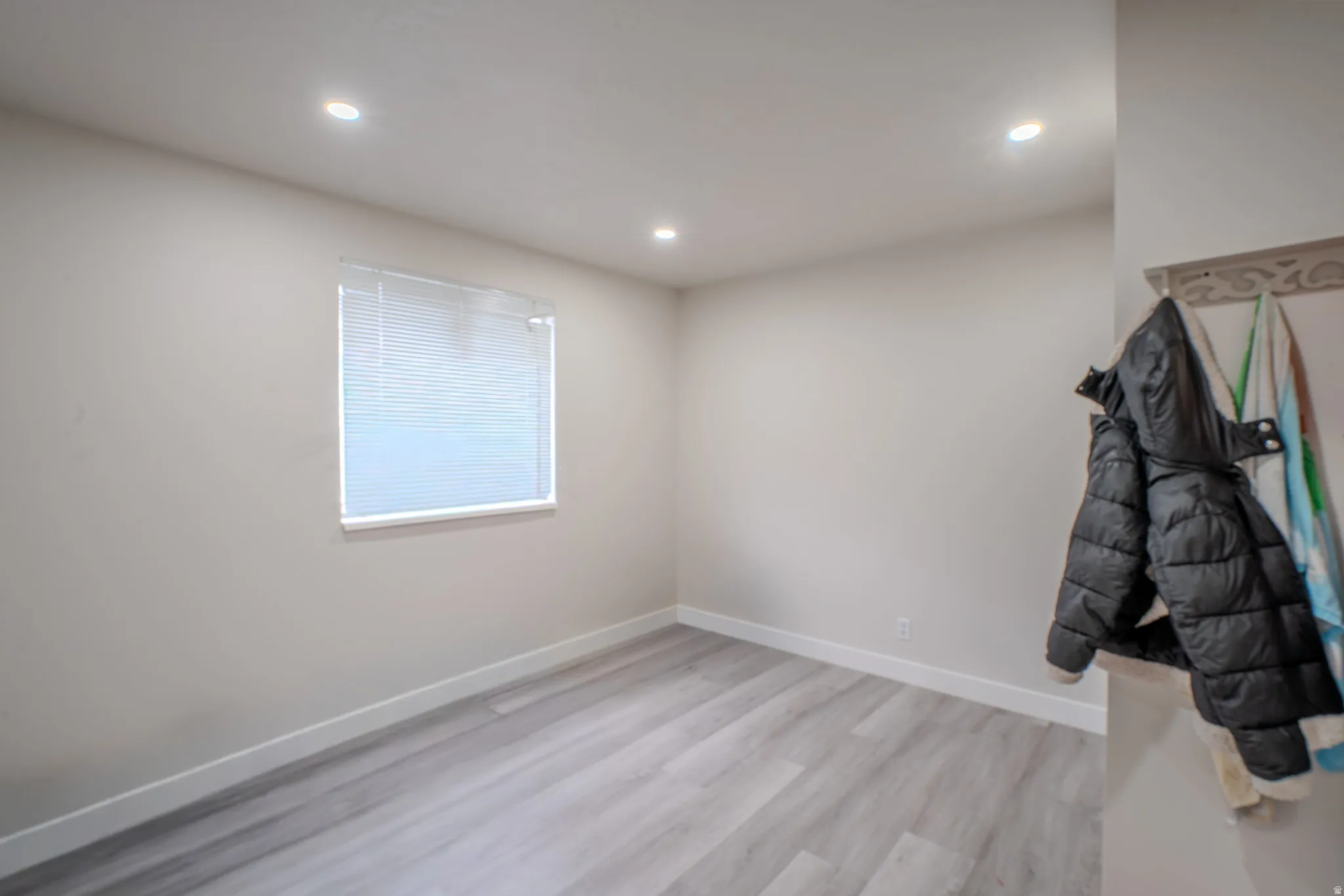 Unfurnished room with recessed lighting and light wood-type flooring