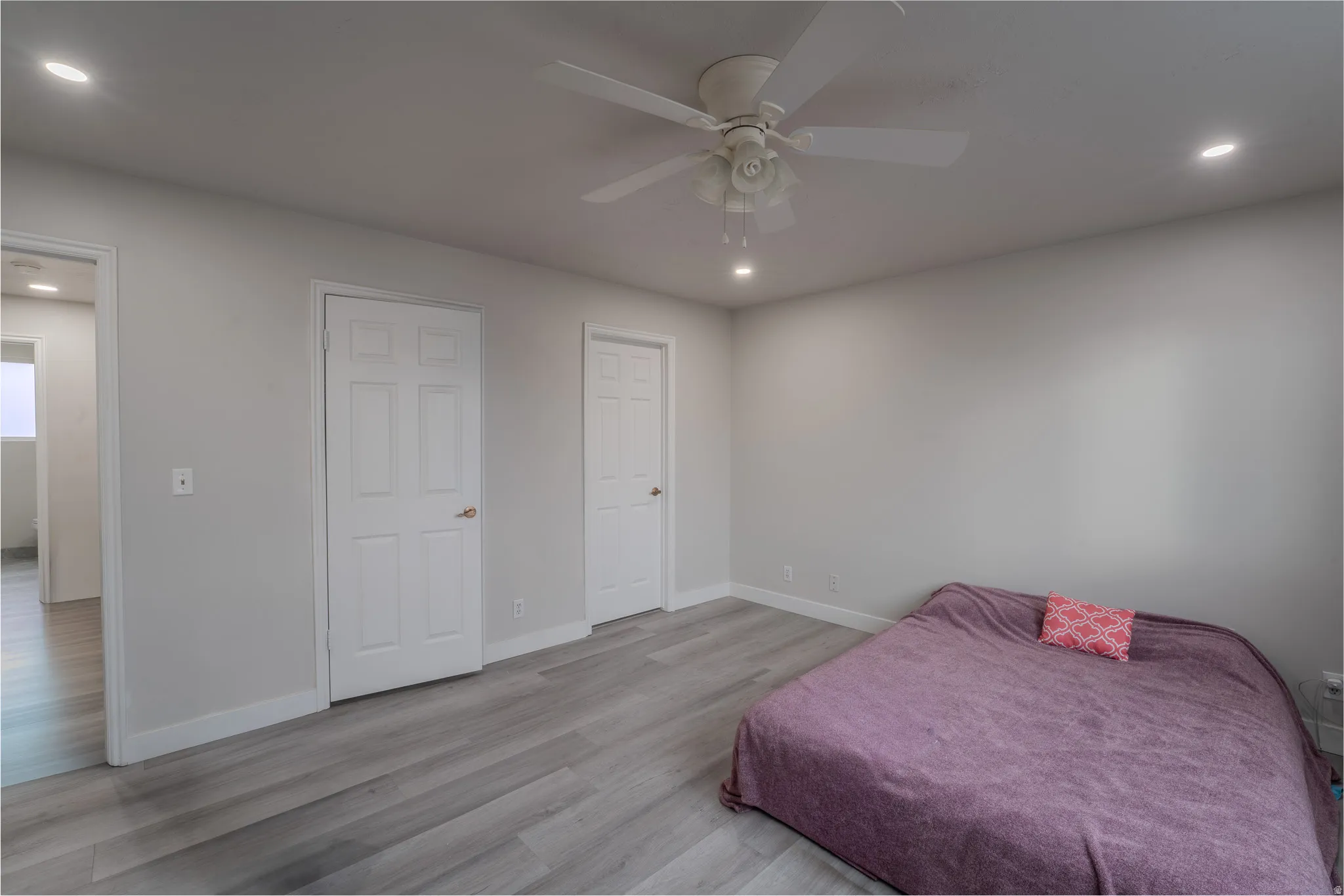 Bedroom with recessed lighting, light wood finished floors, and a ceiling fan