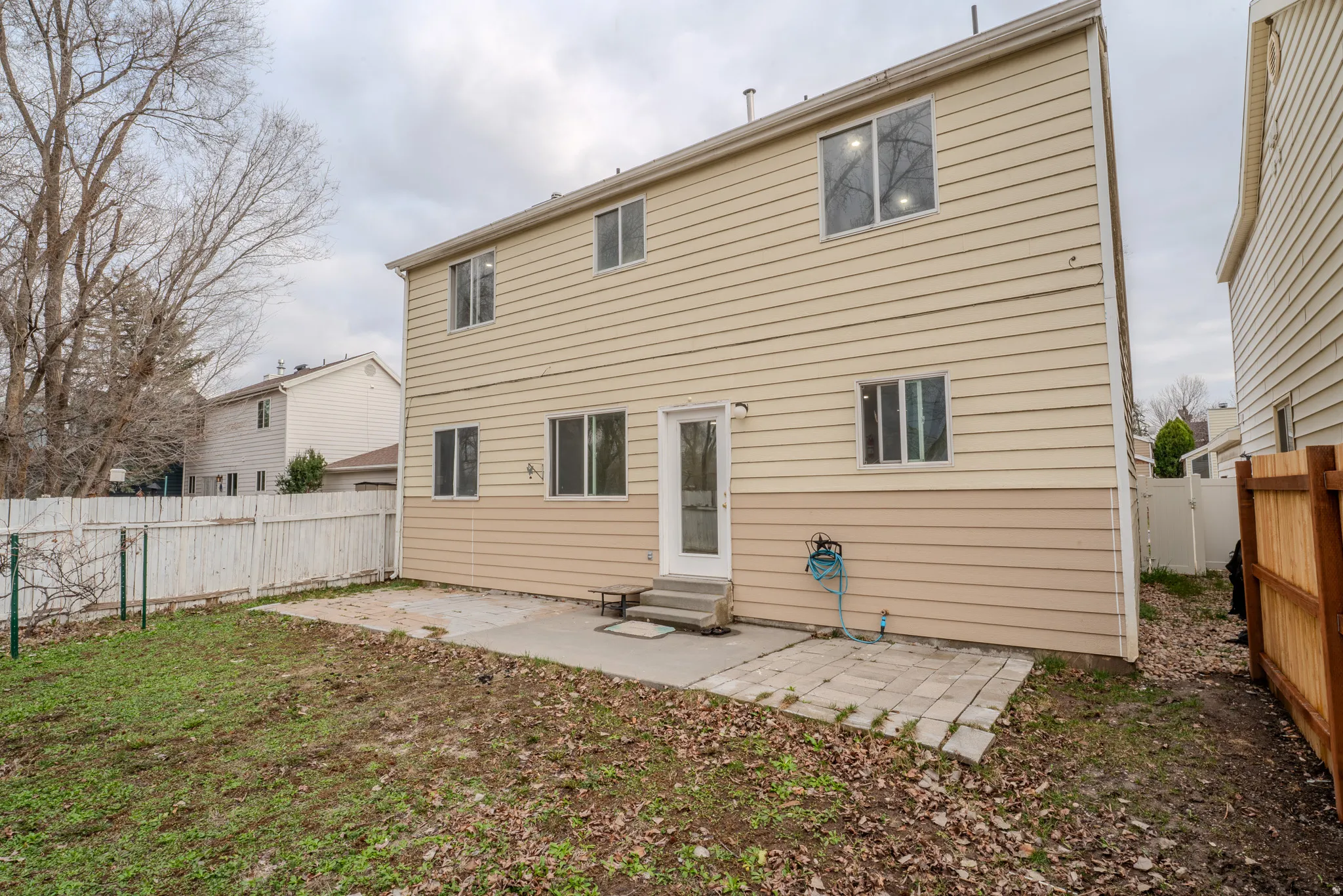 Rear view of property with a patio area, a fenced backyard, and entry steps