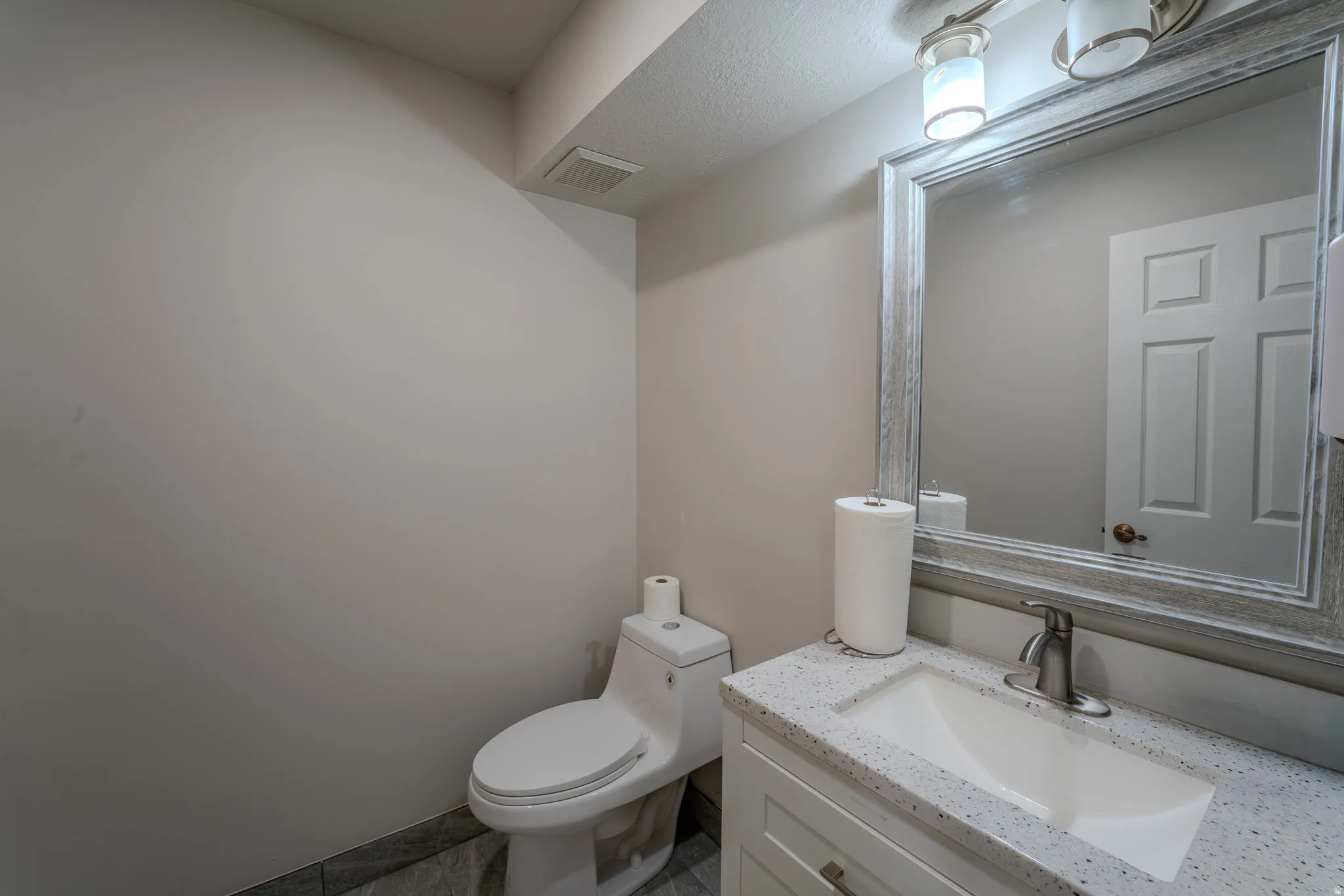 Half bath with toilet and vanity
