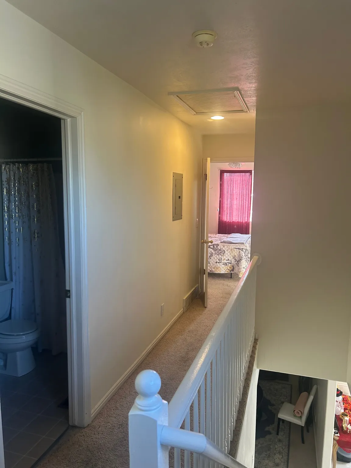 Hall featuring carpet floors, tile patterned floors, and electric panel