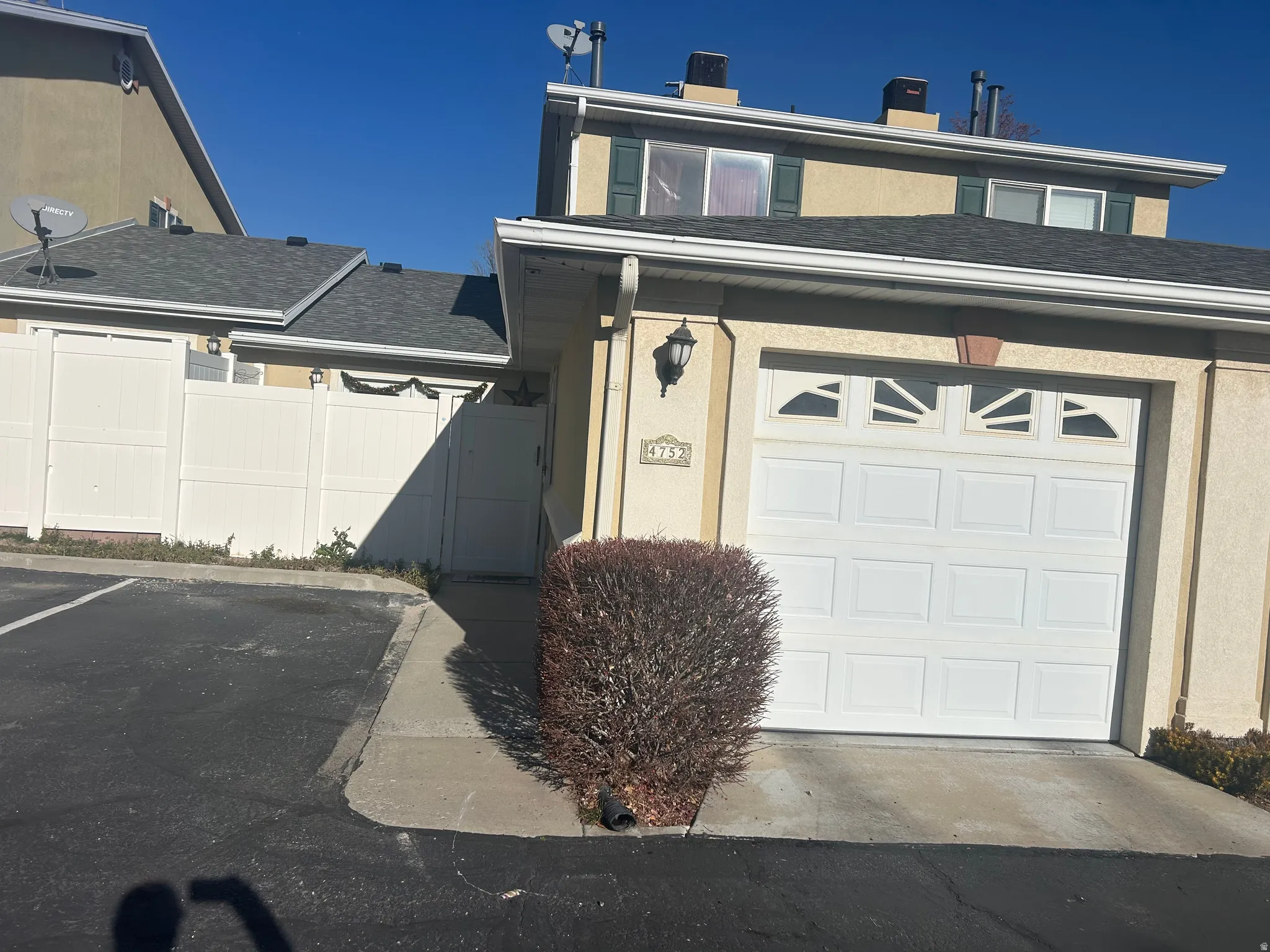 View of front of property featuring a chimney, roof with shingles, and stucco siding