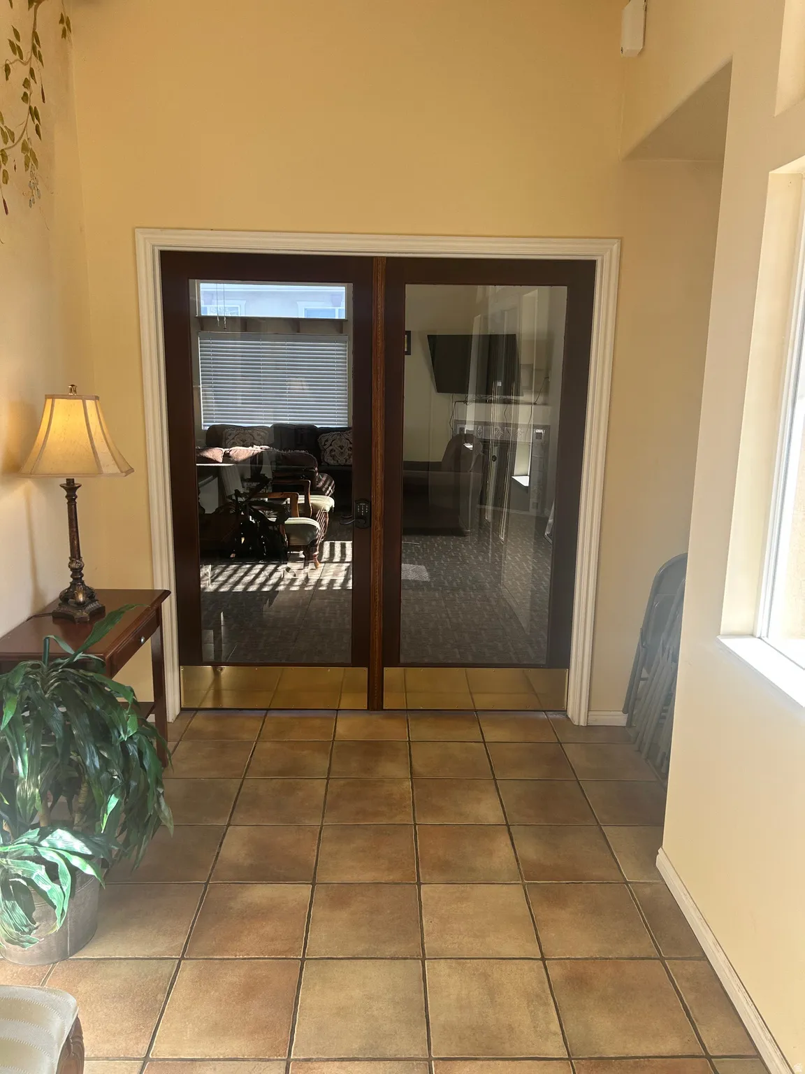 Hallway featuring light tile patterned floors and healthy amount of natural light