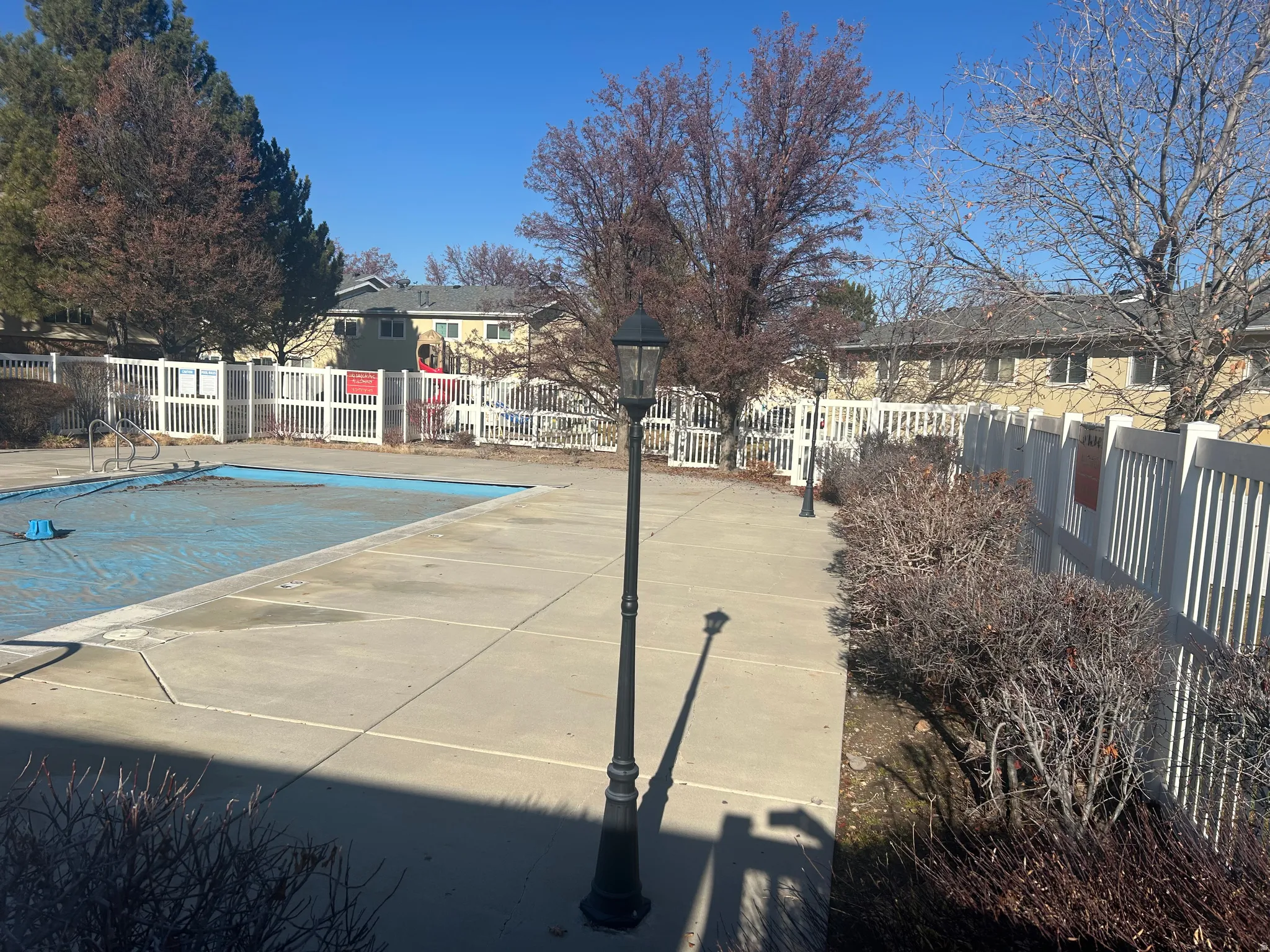 Community pool with a residential view