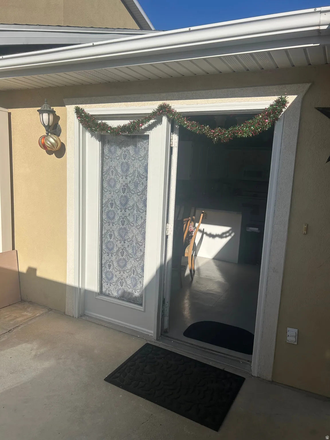 Doorway to property with stucco siding