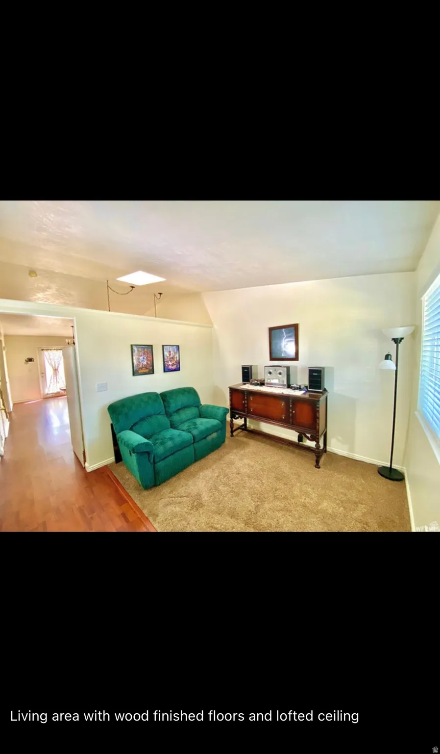 Carpeted living area with baseboards