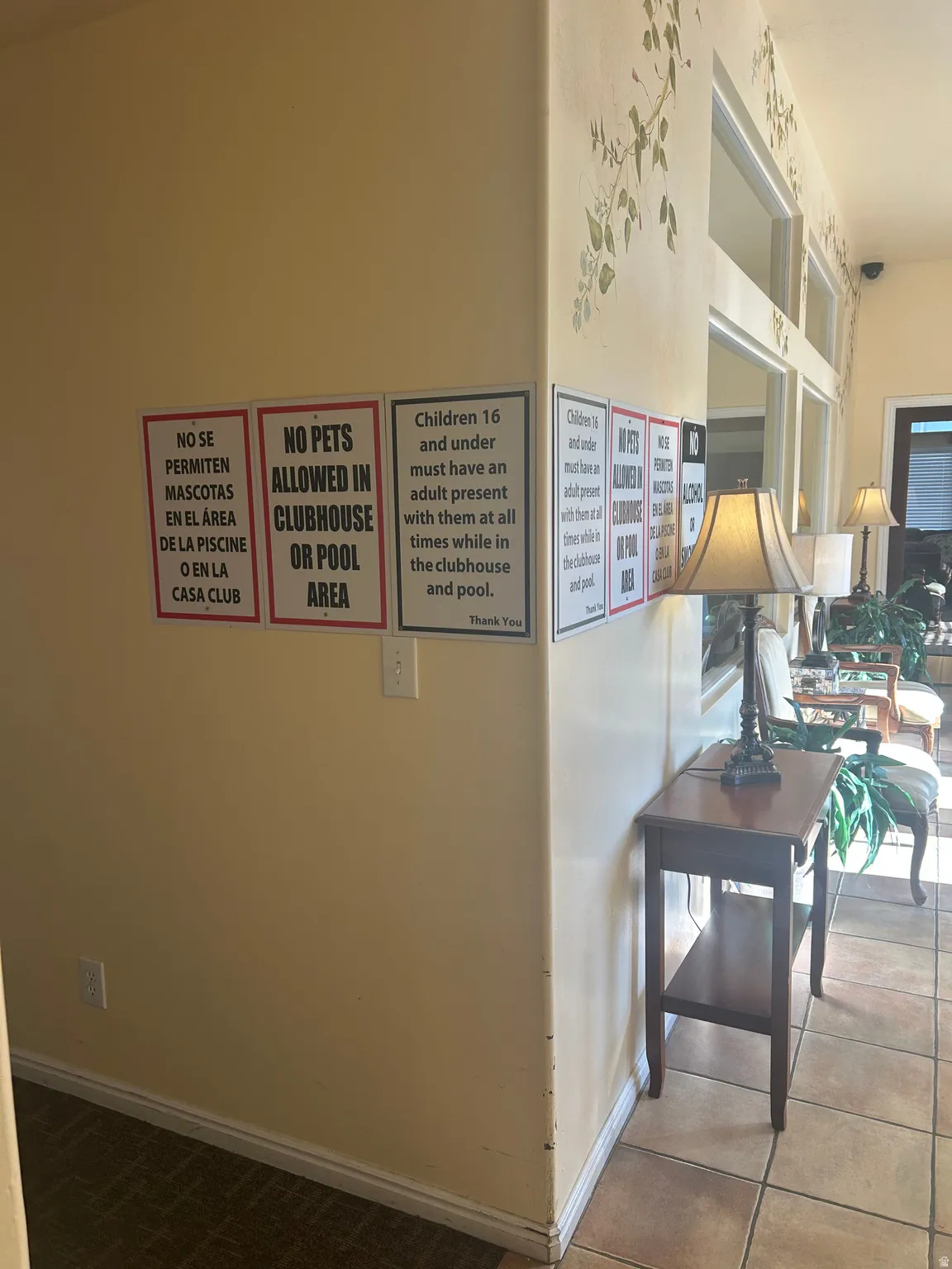 Hallway with baseboards and tile patterned floors