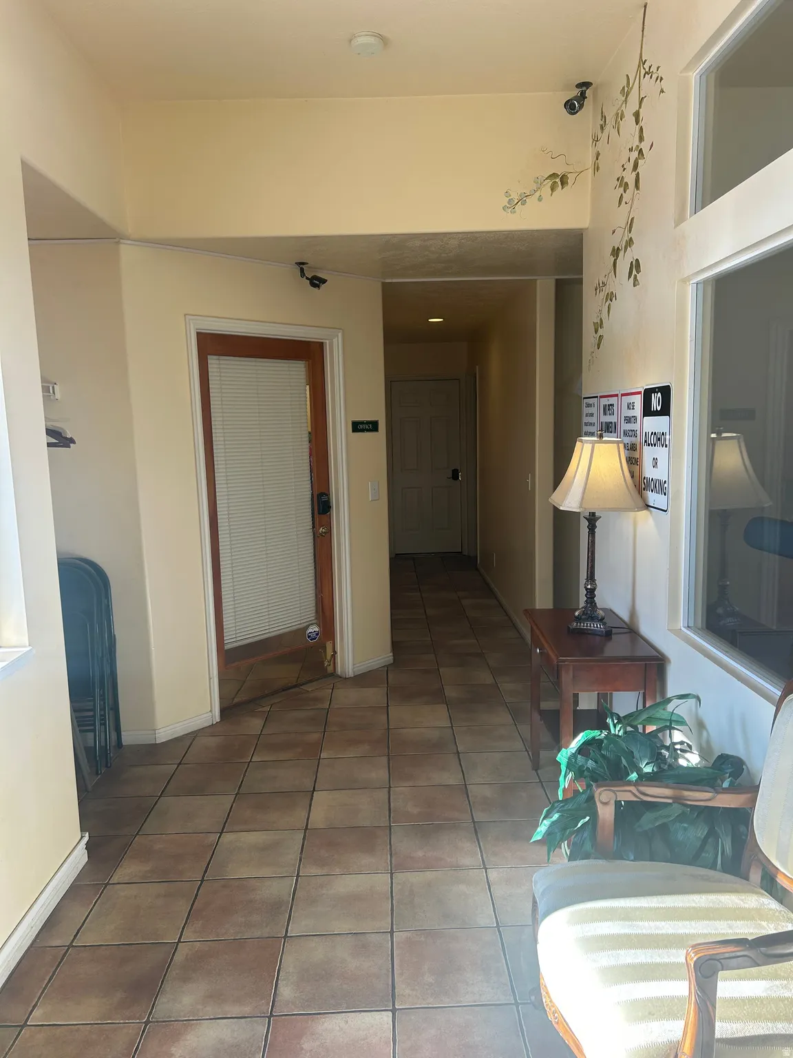 Hall featuring light tile patterned flooring and baseboards