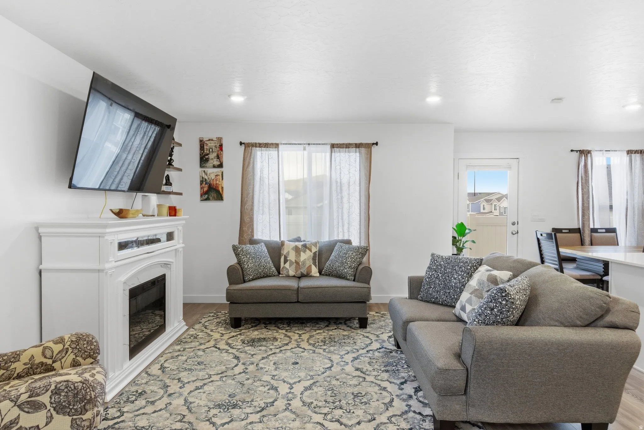 Living area featuring light wood-style floors, a fireplace, and recessed lighting