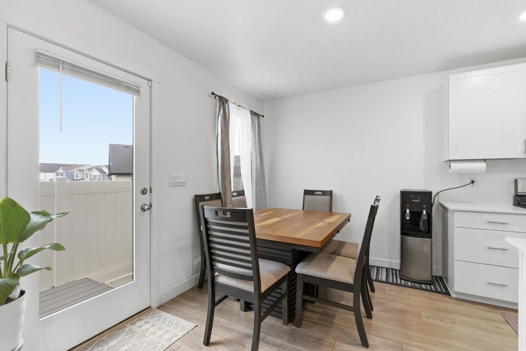 Dining space with light wood-type flooring and recessed lighting
