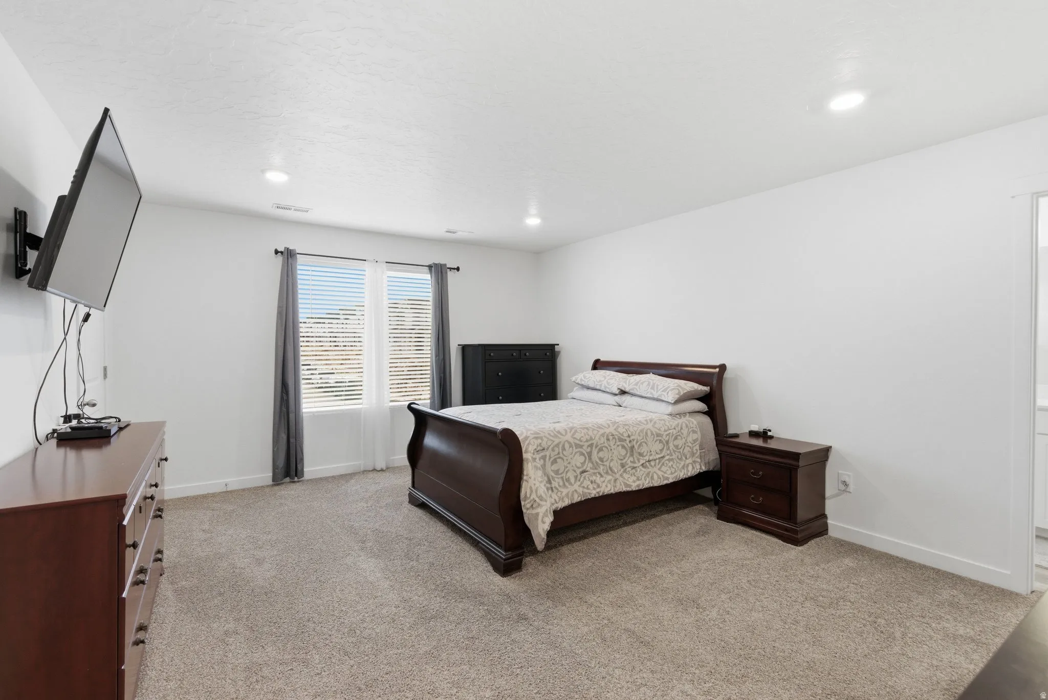 Bedroom featuring light colored carpet and recessed lighting