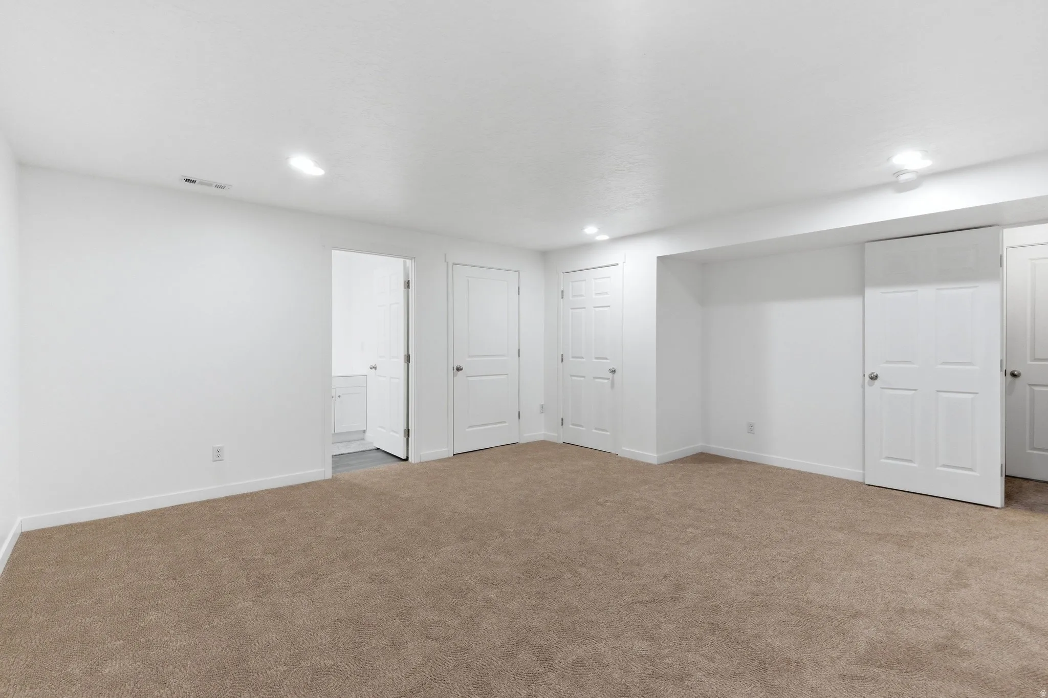 Finished below grade area featuring carpet flooring and recessed lighting