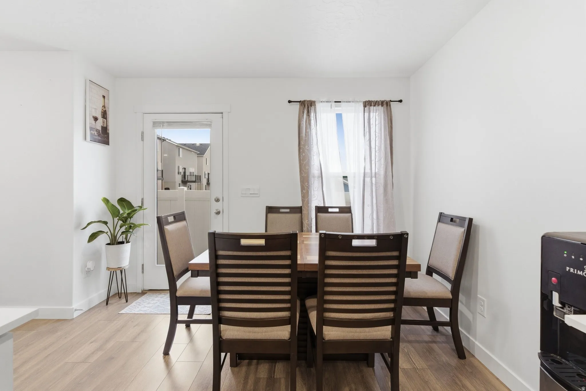 Dining area with light wood-style floors