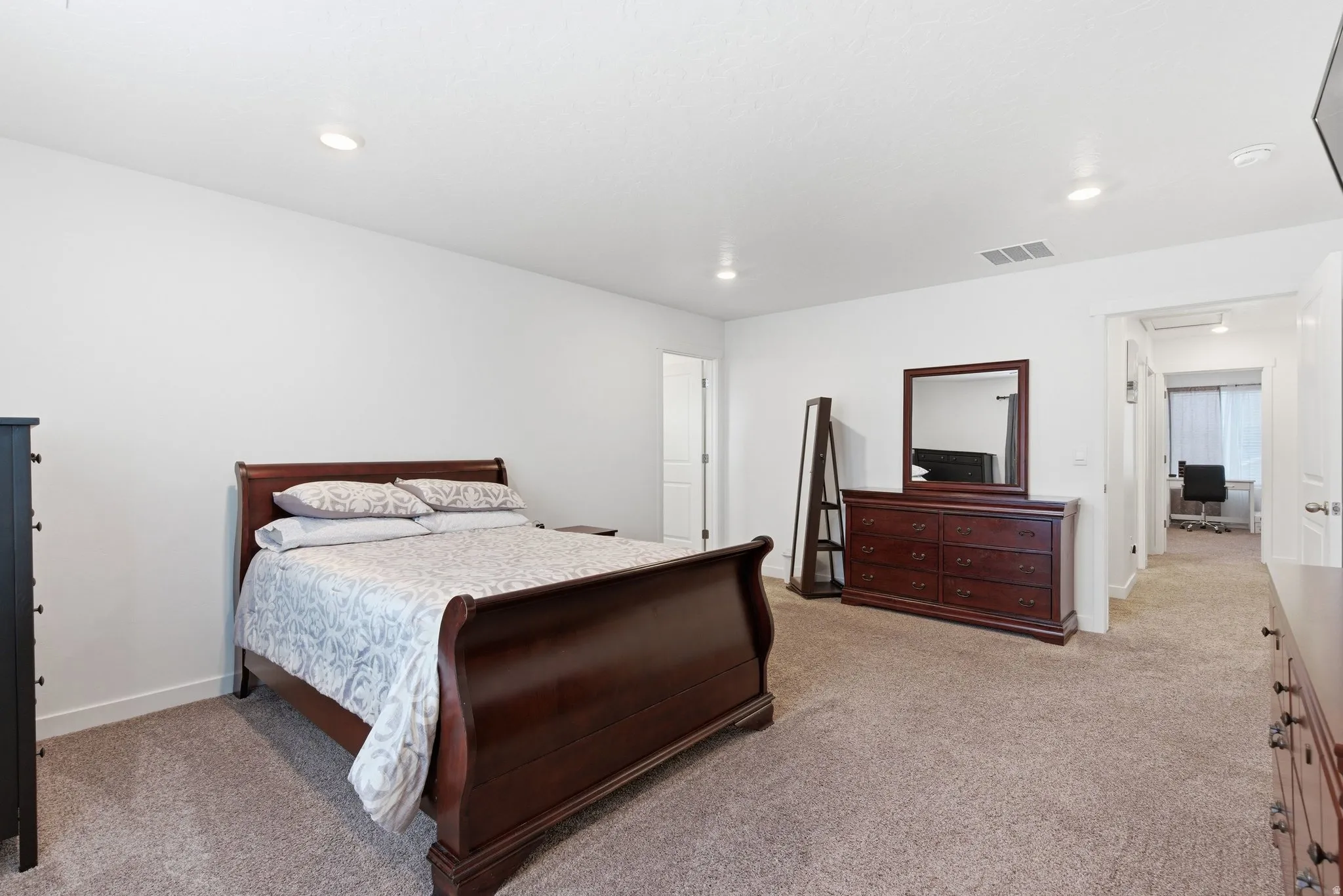 Bedroom with light carpet and recessed lighting