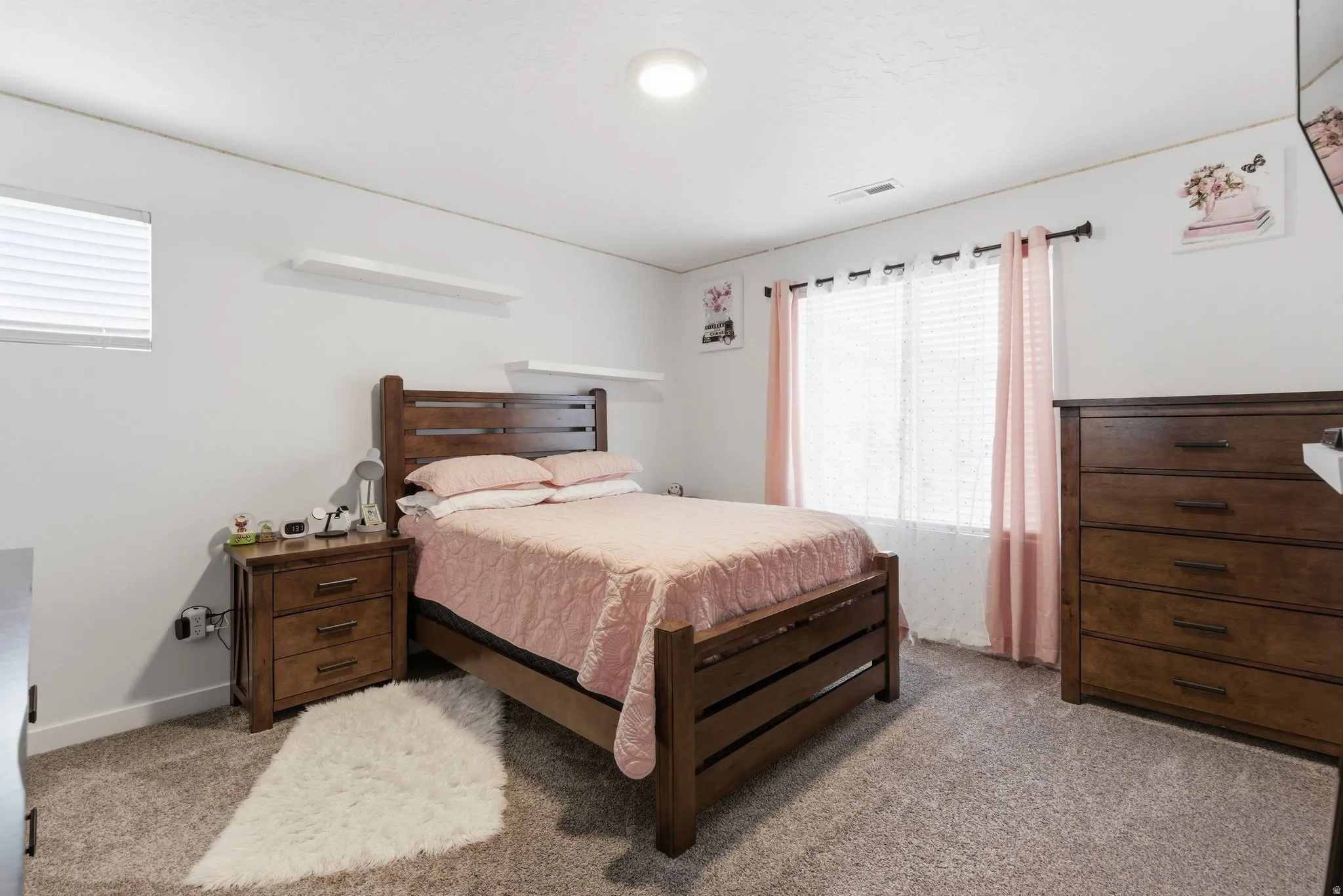 Bedroom featuring light carpet