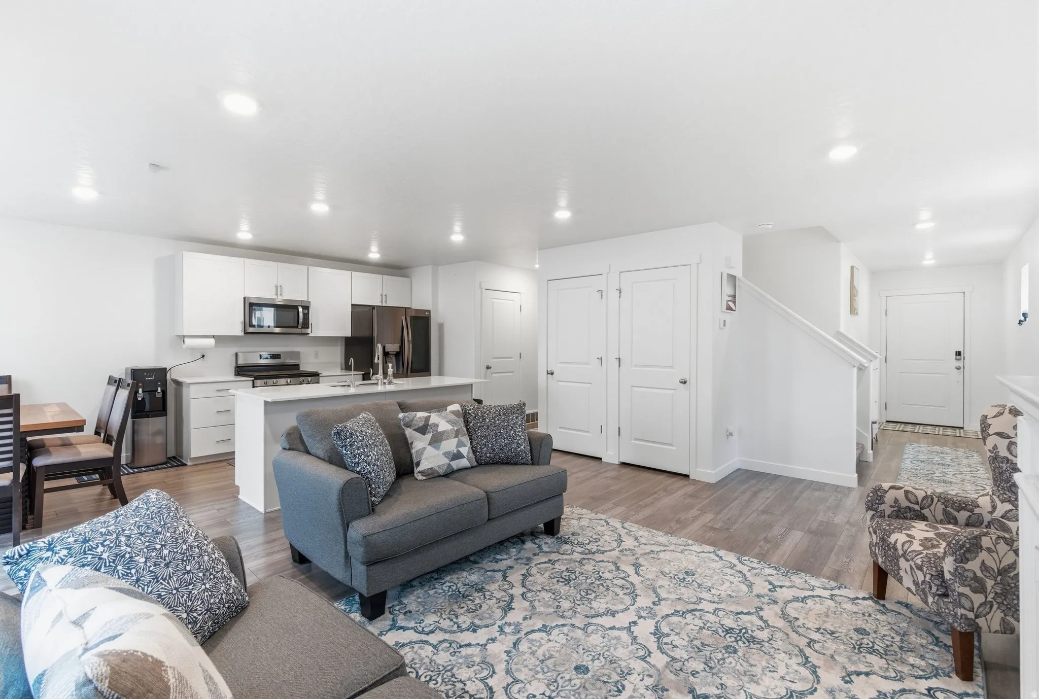 Living area featuring light wood-style flooring and recessed lighting