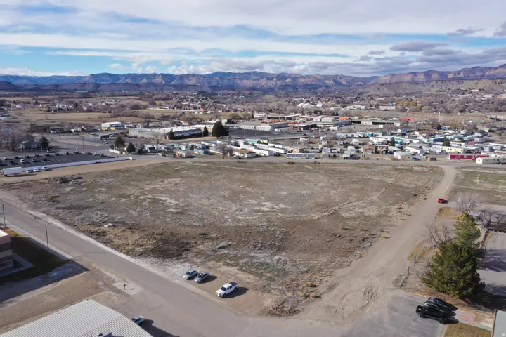 Aerial overview of property's location featuring a mountainous background