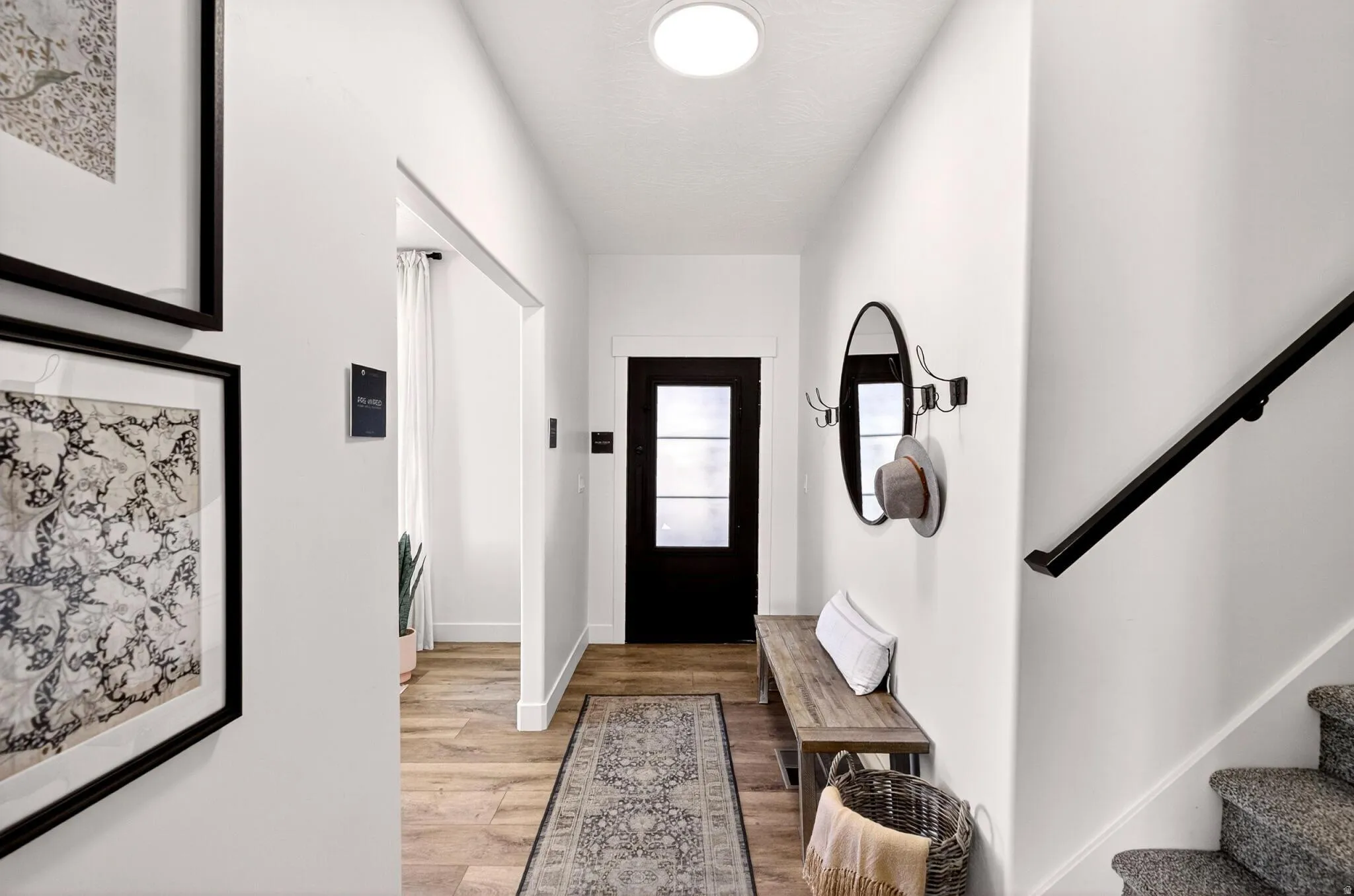 Entryway featuring stairway and light wood-style floors