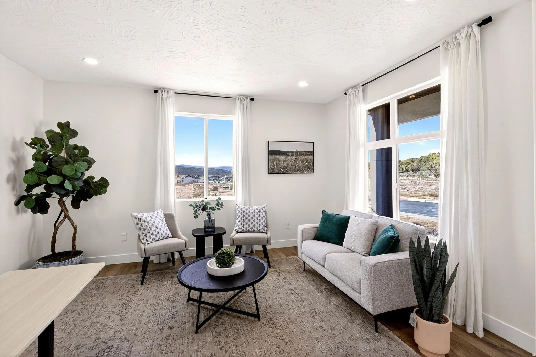 Living area with wood finished floors, recessed lighting, and a mountain view