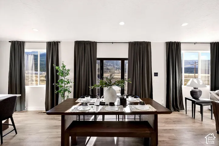 Dining area featuring light wood-type flooring and recessed lighting