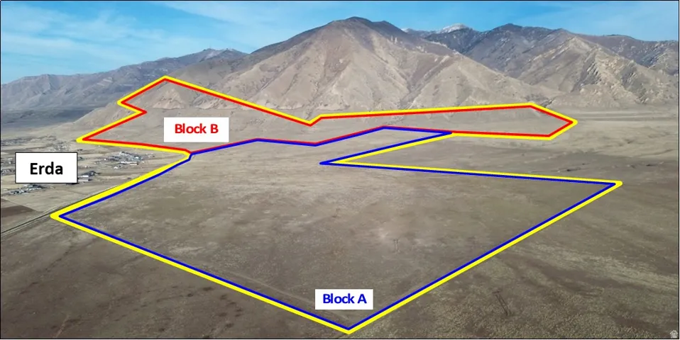 Aerial view of property's location featuring property parcel outlined and a mountainous background