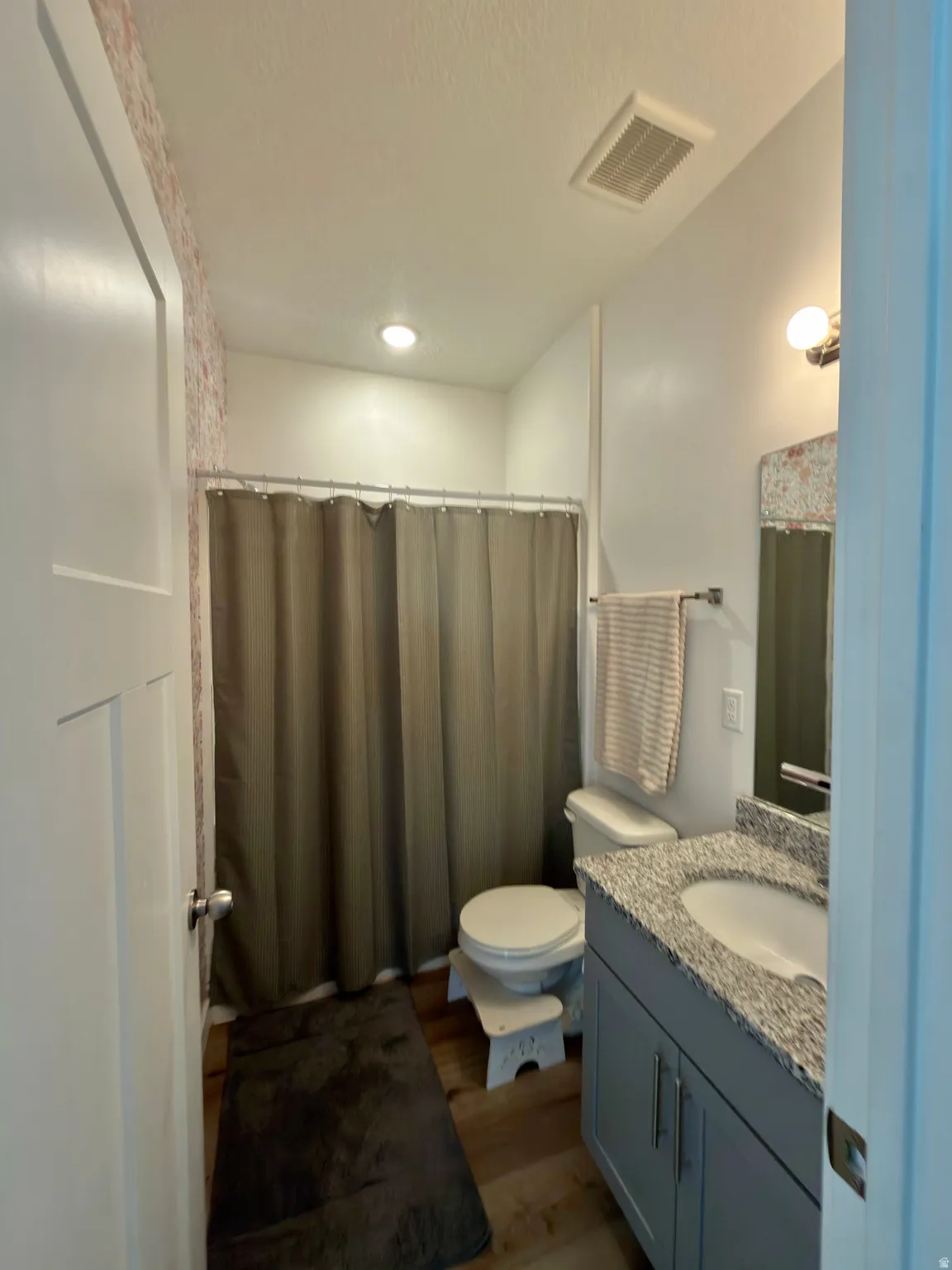 Full bathroom featuring vanity, a shower with curtain, dark wood-style flooring, and recessed lighting