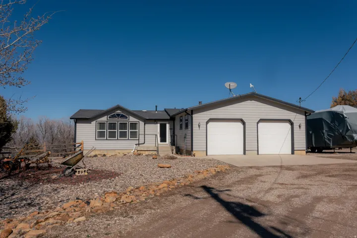 Ranch-style house featuring concrete driveway and a garage