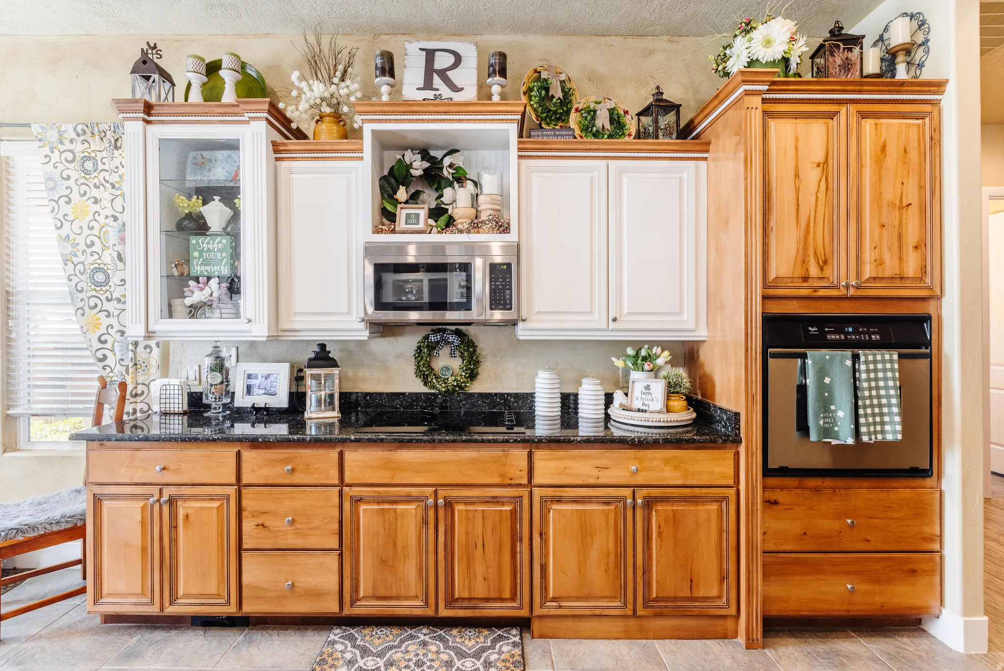 Kitchen with stainless steel appliances, dark stone countertops, and wood finish cabinetry