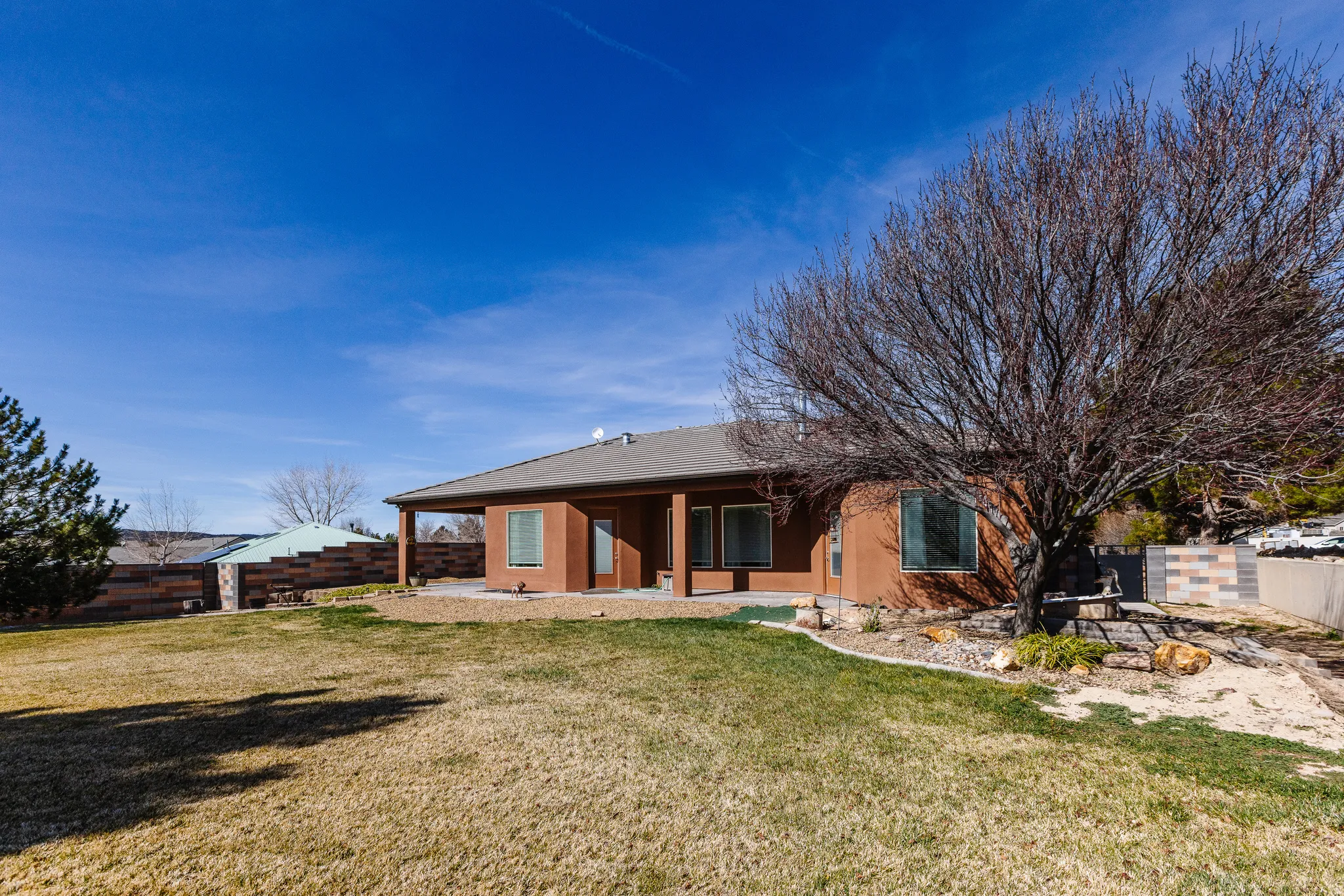 Back of property with a patio area, a fenced backyard, and stucco siding