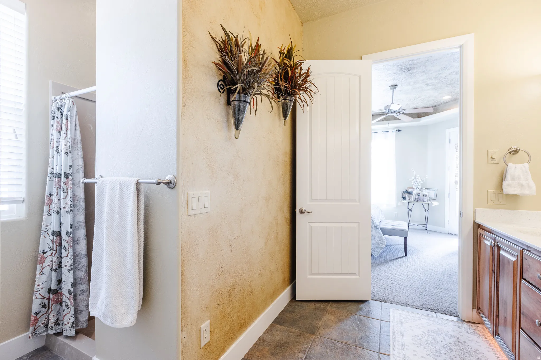 Full bathroom featuring vanity, a shower stall, a ceiling fan, and healthy amount of natural light
