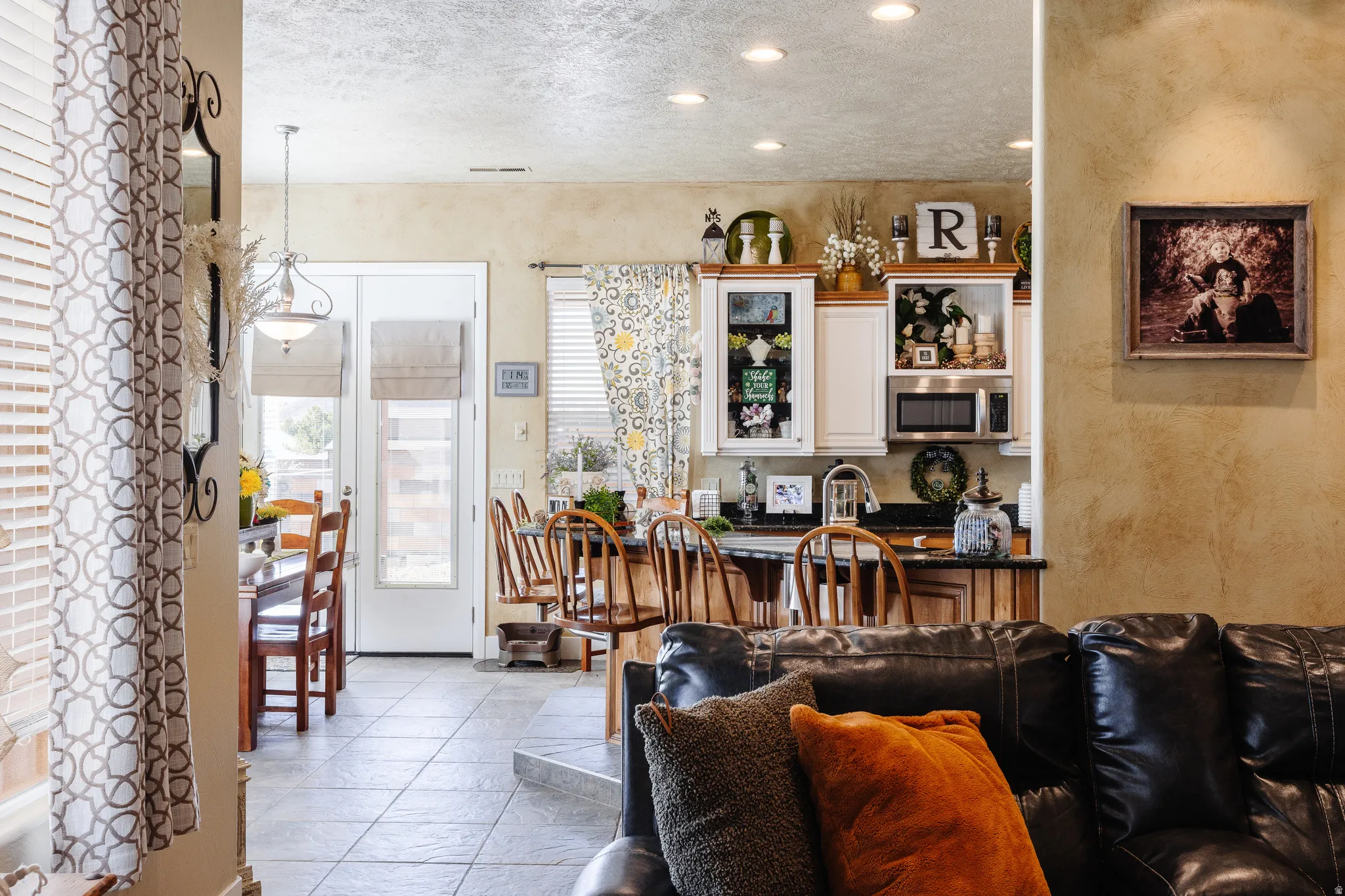 Living area featuring a textured wall, a textured ceiling, and recessed lighting