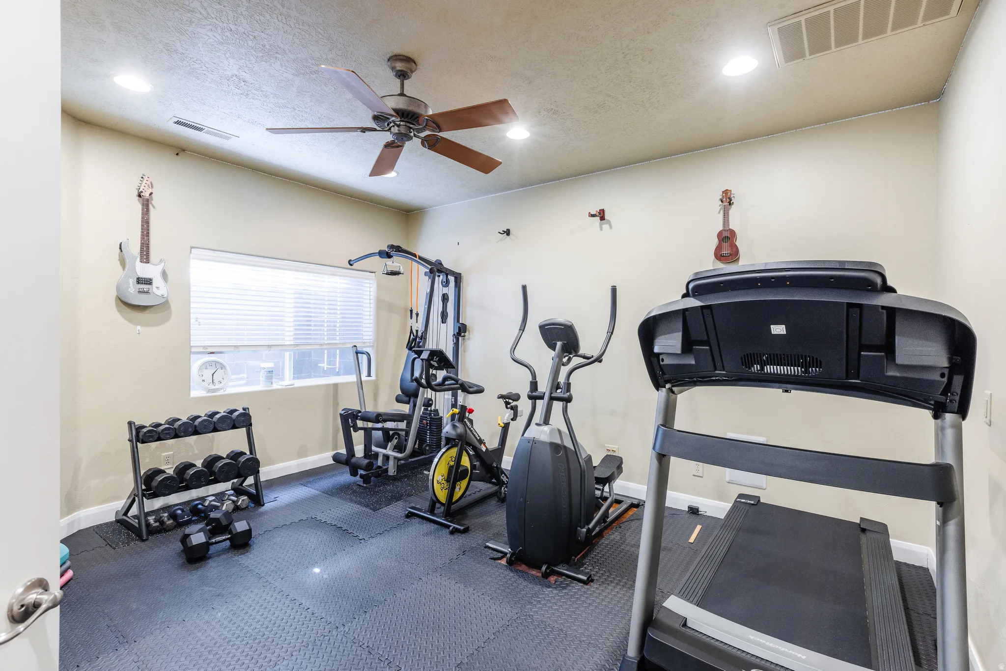 Workout room with a textured ceiling, a ceiling fan, and recessed lighting