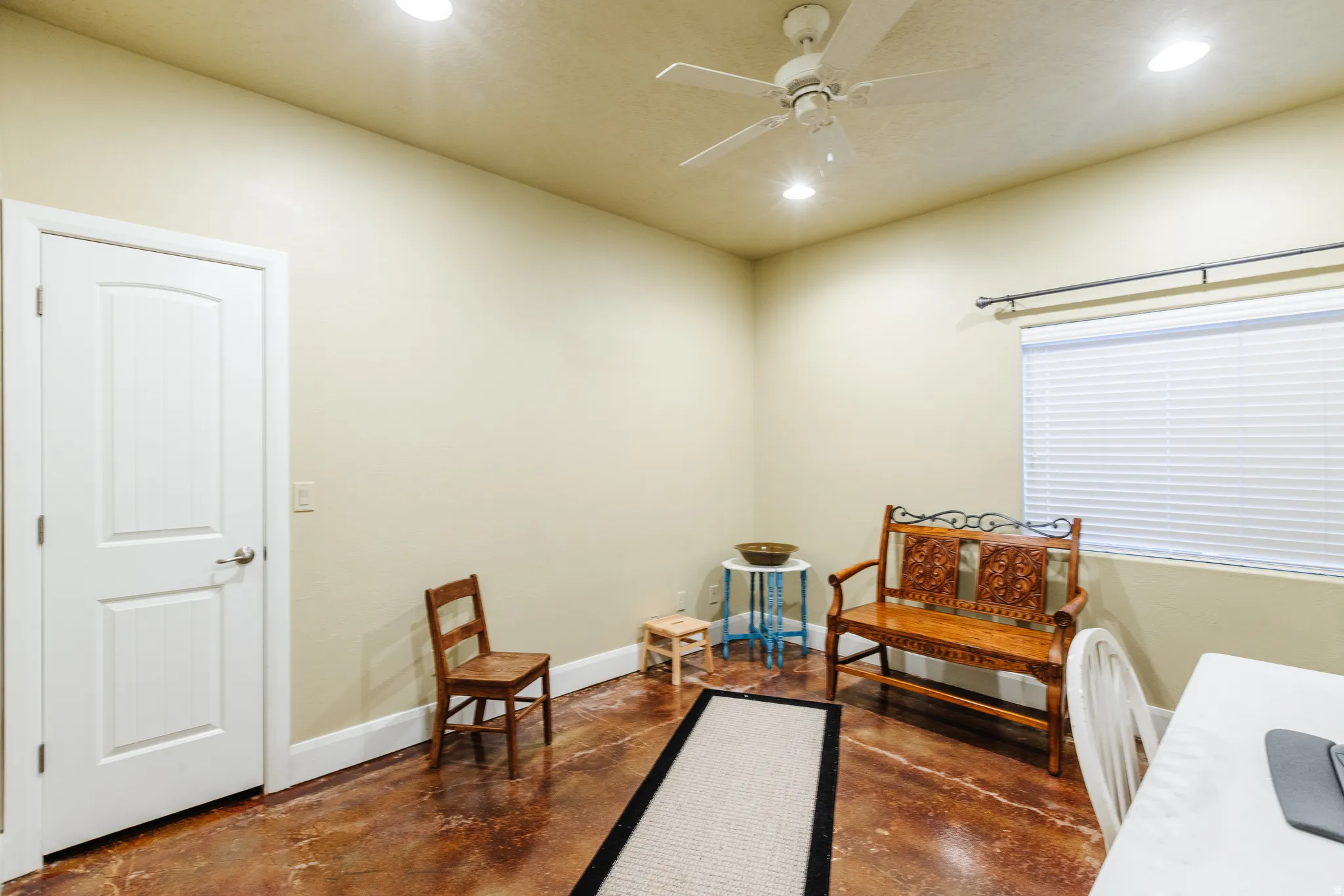 Sitting room featuring concrete floors, recessed lighting, and ceiling fan