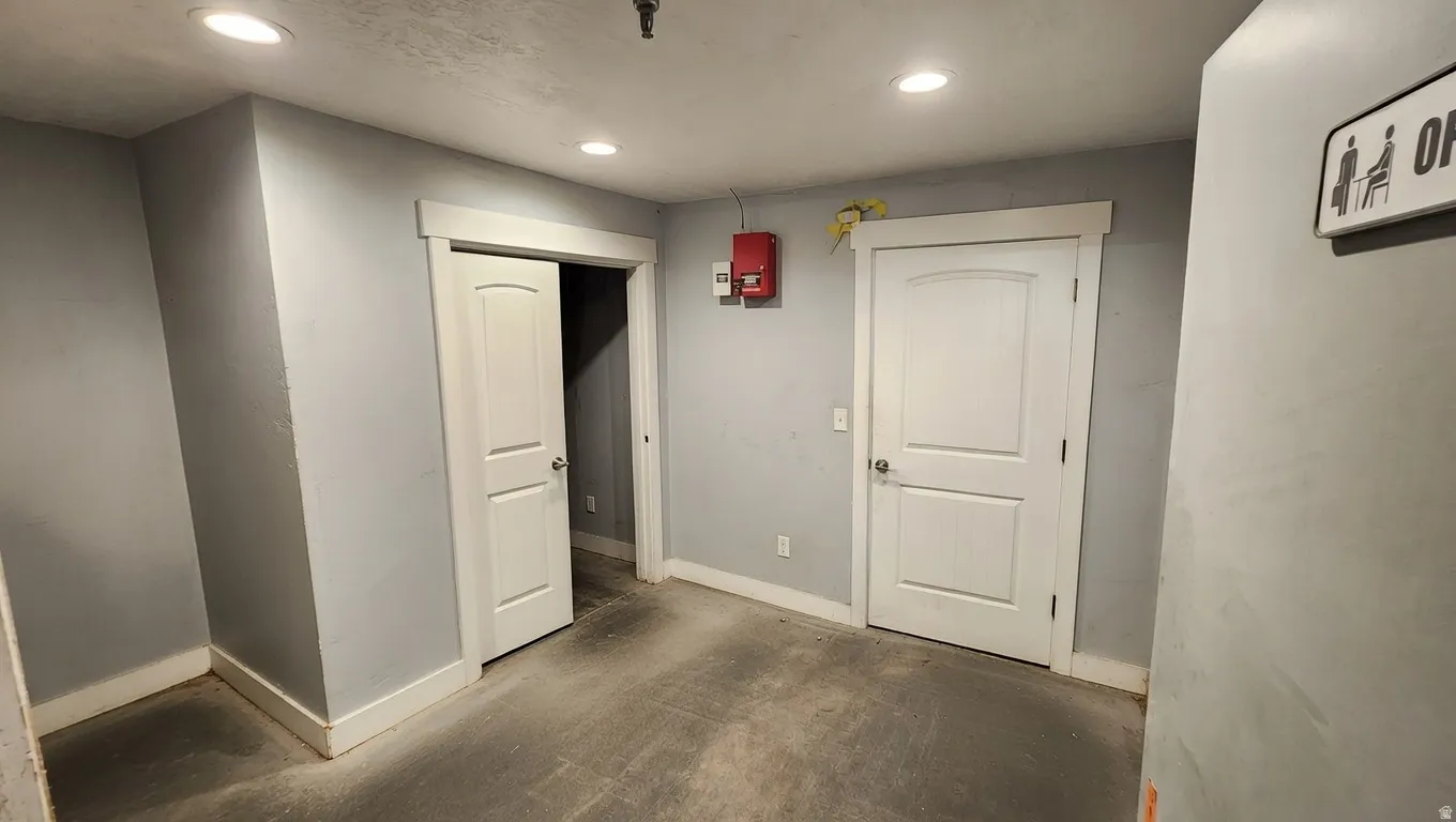 Corridor with baseboards and recessed lighting