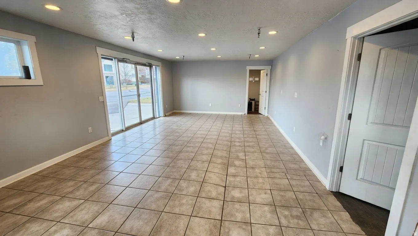 Spare room featuring recessed lighting, a textured ceiling, and light tile patterned floors