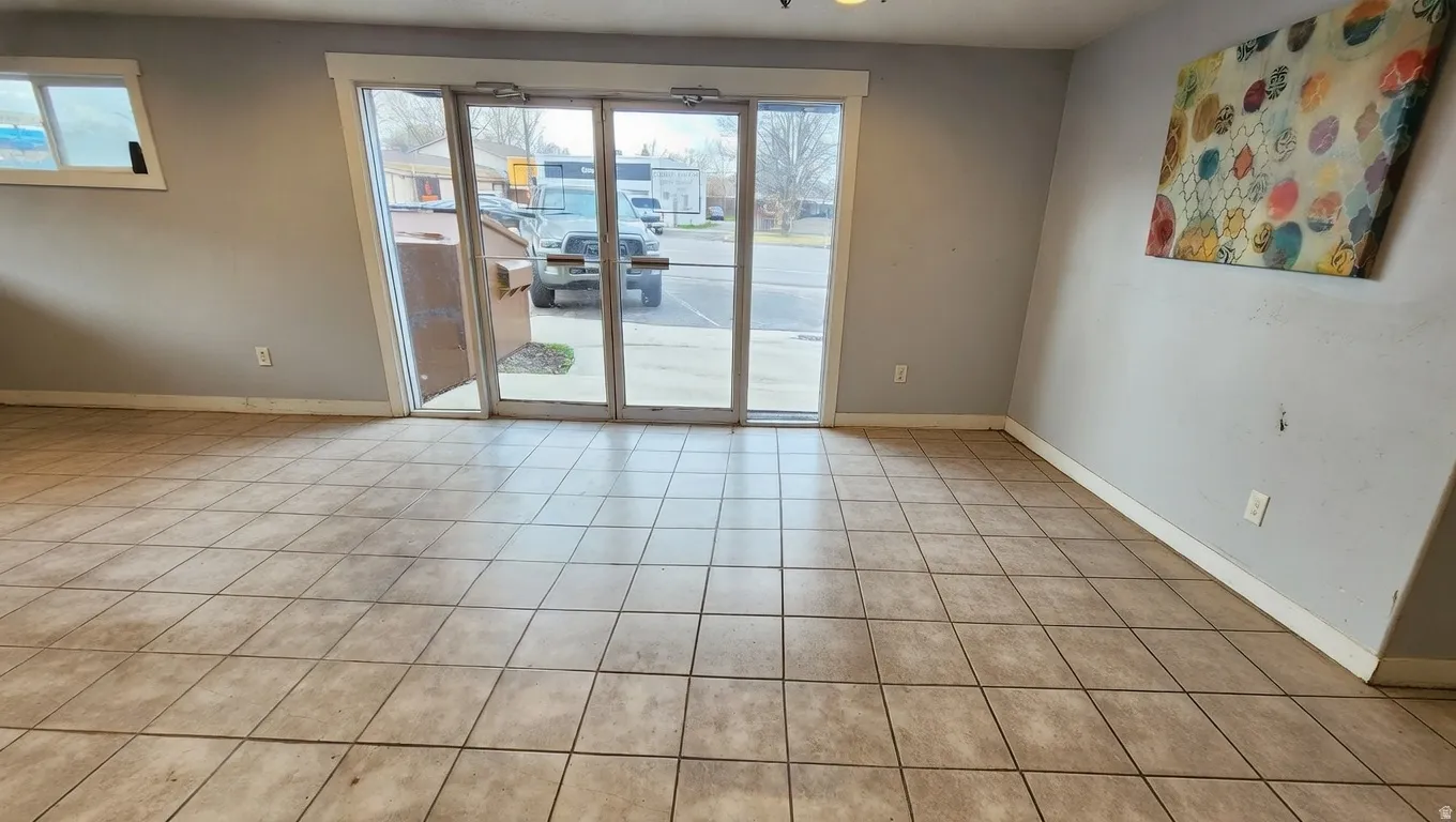 Spare room with light tile patterned flooring and healthy amount of natural light