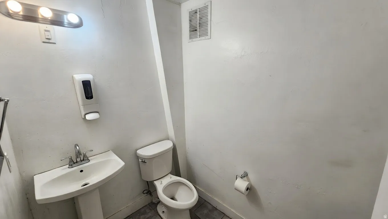Bathroom featuring toilet and baseboards