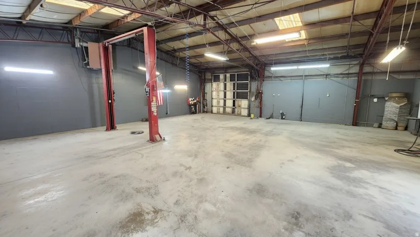 Garage featuring concrete block wall